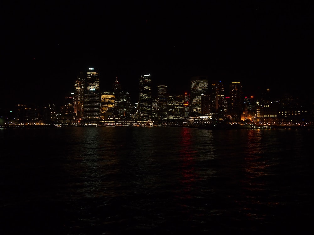 high-rise buildings near sea at nighttime