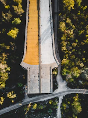 Aerial view of a highway bridge under construction surrounded by green landscape.