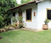 white concrete house beside green leafed trees