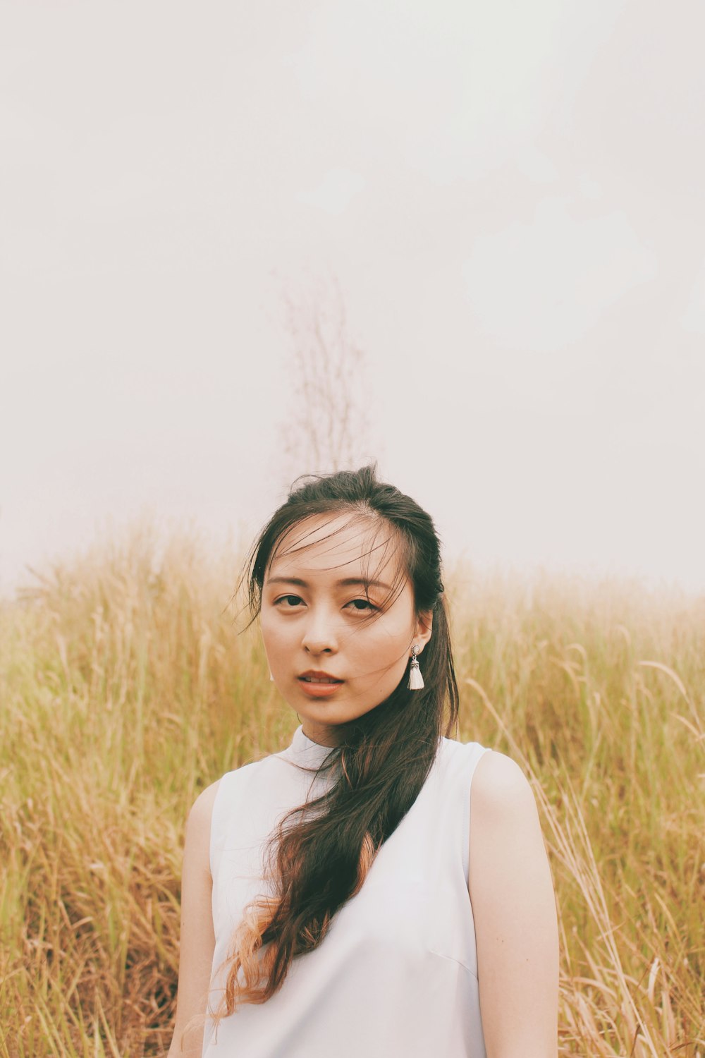 woman standing on dried grass field