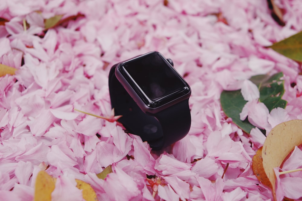 black apple watch on pink and white flower petals