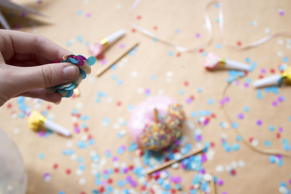 person holding assorted-color decors