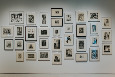 Wall with a minimalistic picture gallery featuring natural wood frames and soft neutral prints.