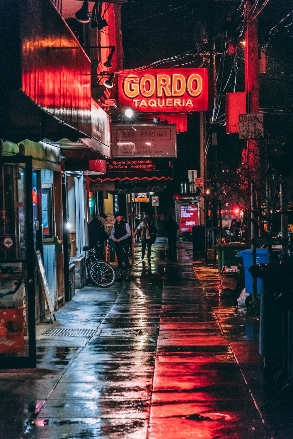 man standing beside store facade