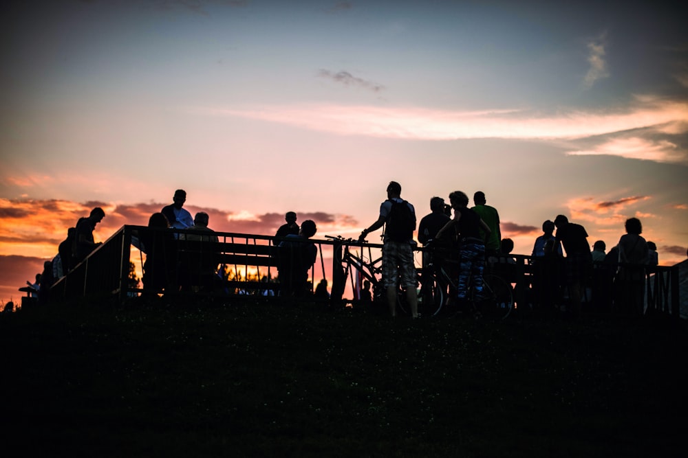 silhouette of people standing on the balcony