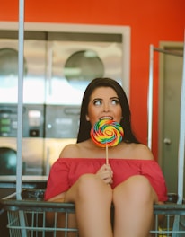 woman holding lollipop inside basket
