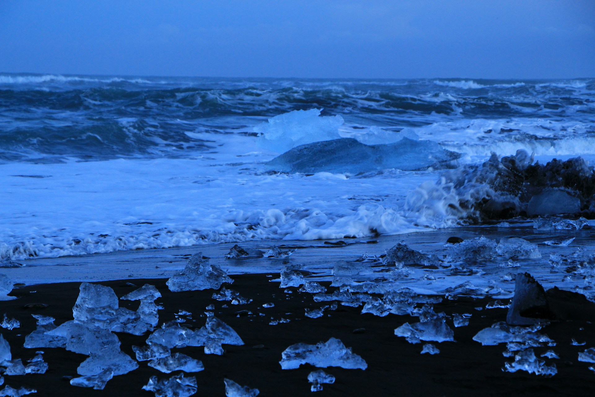 photograph of water rushing on shore