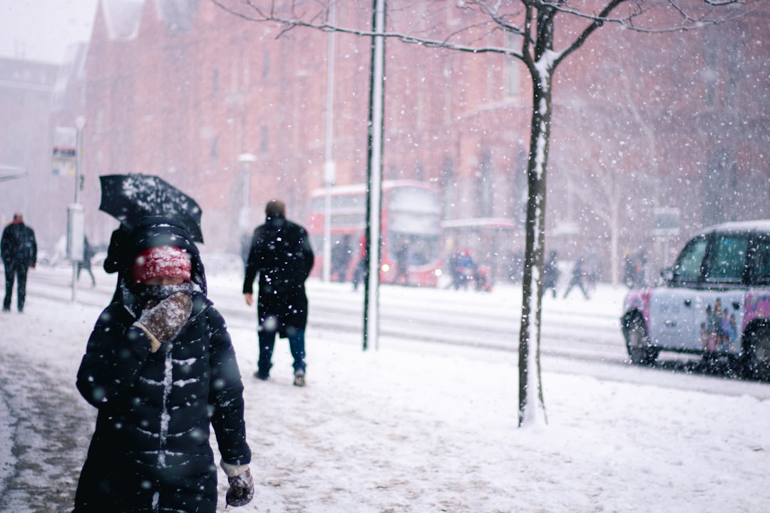 person walking on snow-covered road, Snow in central London