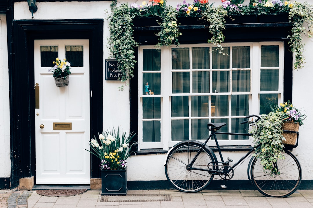 black fixie bike near white wooden door