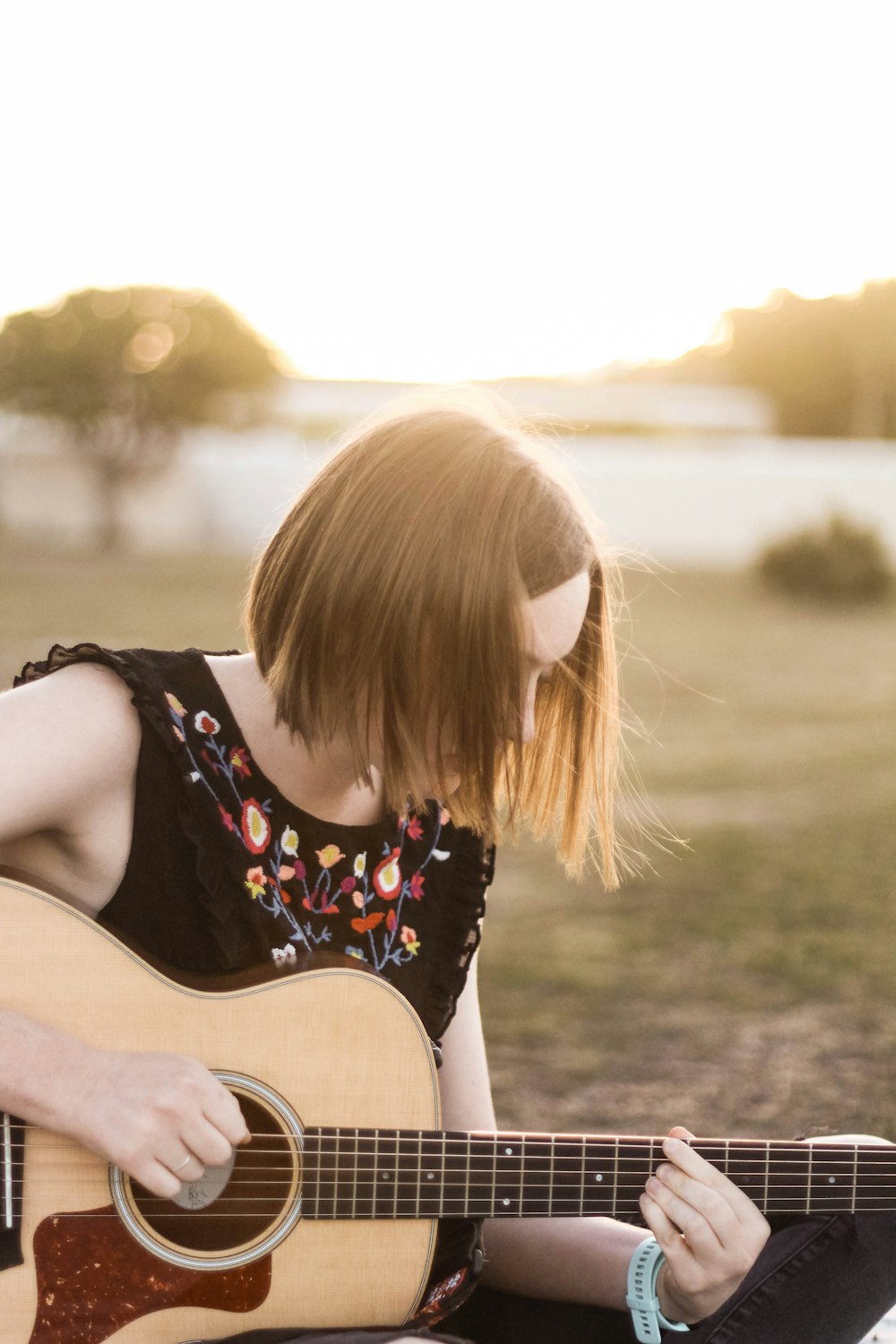 woman playing acoustic guitar