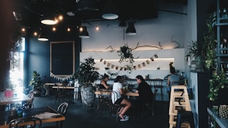 Cozy interior of Black Doves café with warm lighting and customers chatting.