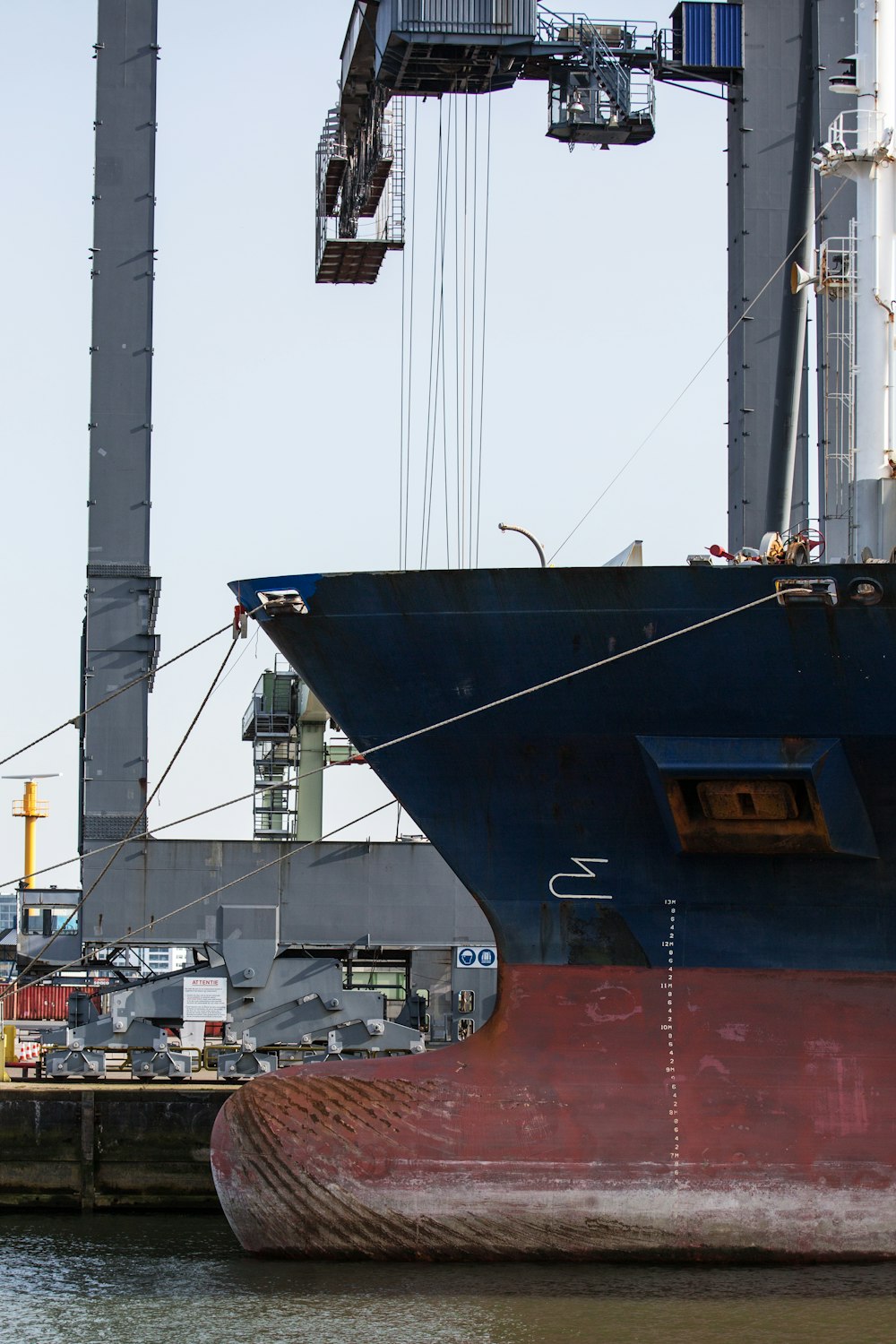 blue and red ship at daytime