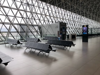 black metal gang chairs on white ceramic flooring