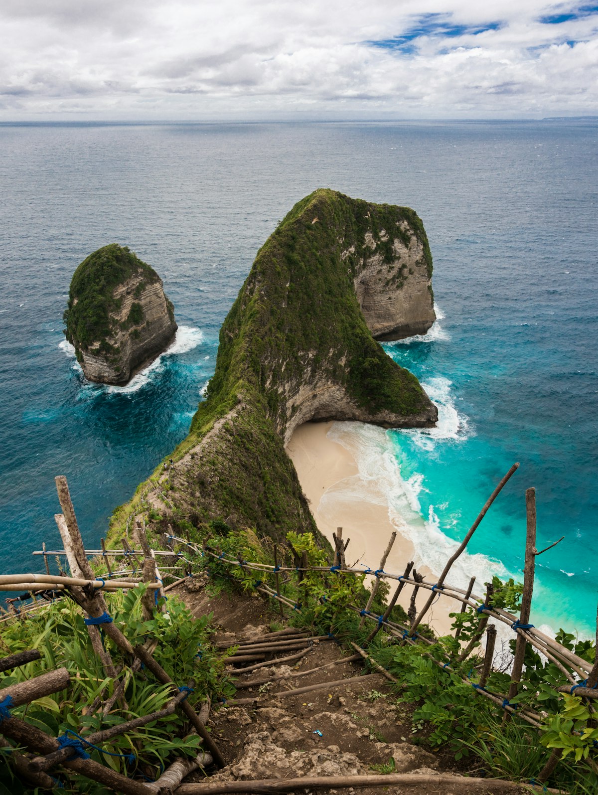 Nusa Penida January — dramatic Kelingking cliffs under monsoon clouds