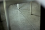 A close-up of a repaired tile floor in a business setting.