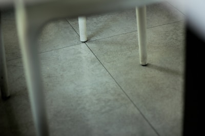 A close-up of a repaired tile floor in a business setting.