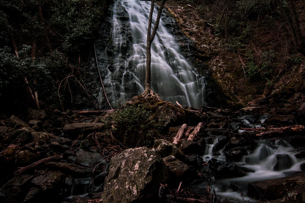 photo of waterfalls near green grass