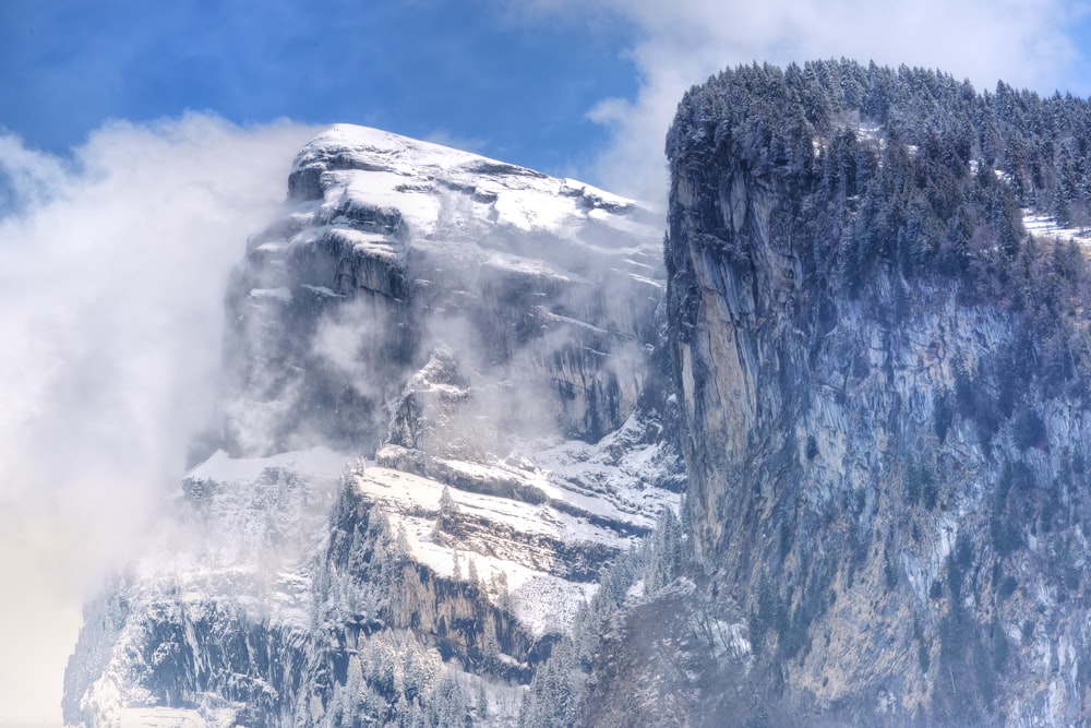 snow-covered cliff during daytime