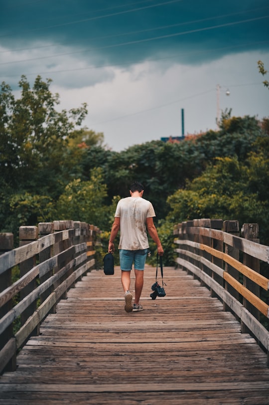 man walking on brown wooden bridge in Minnesota United States