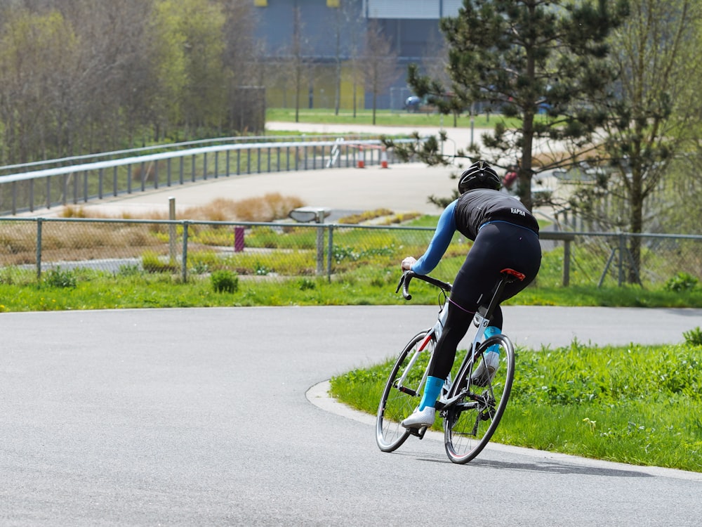 cyclist riding on bicycle through corner