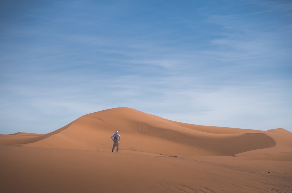 person standing on desert