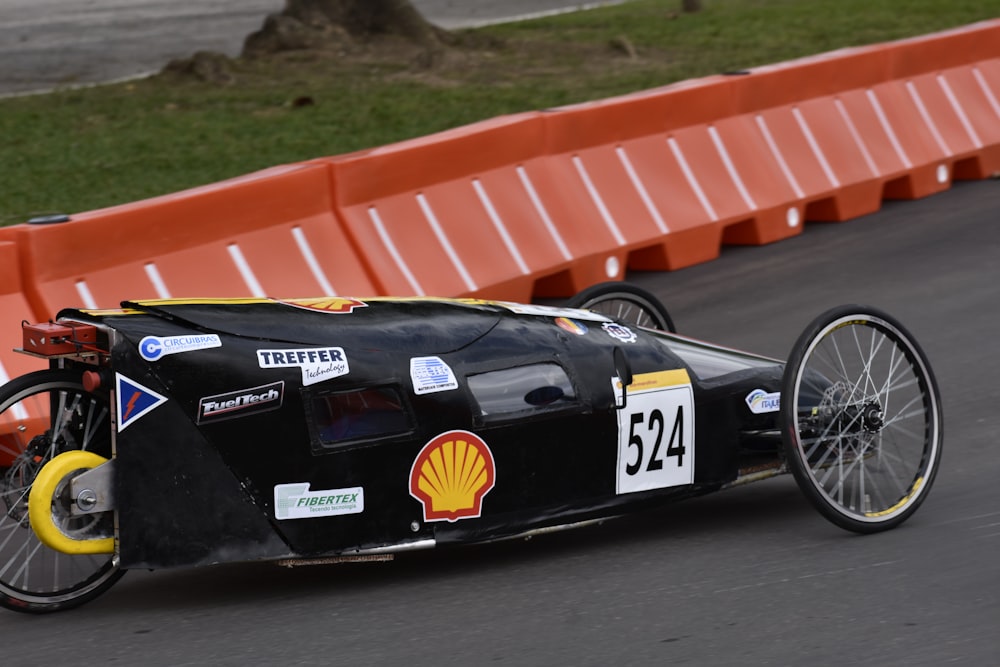 black racing car on track during day time