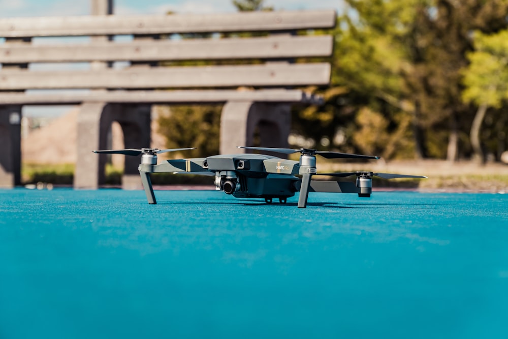 black quadcopter on blue floor