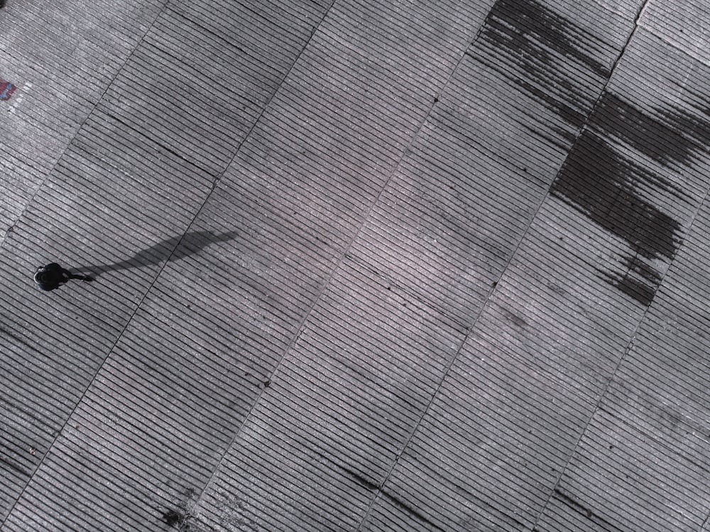 man standing on concrete pavement