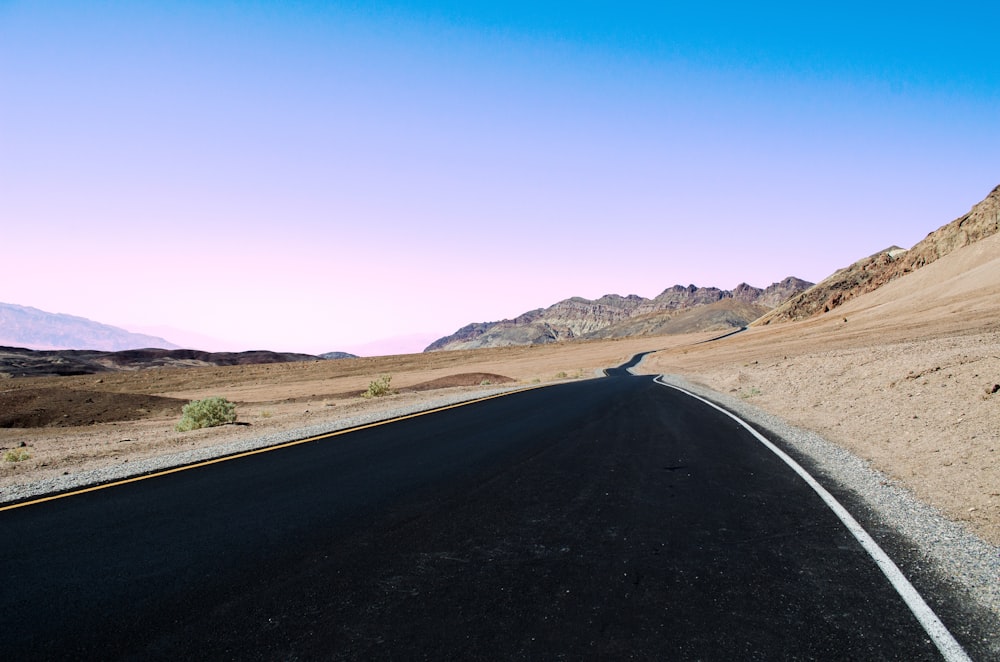 gray concrete road in desert