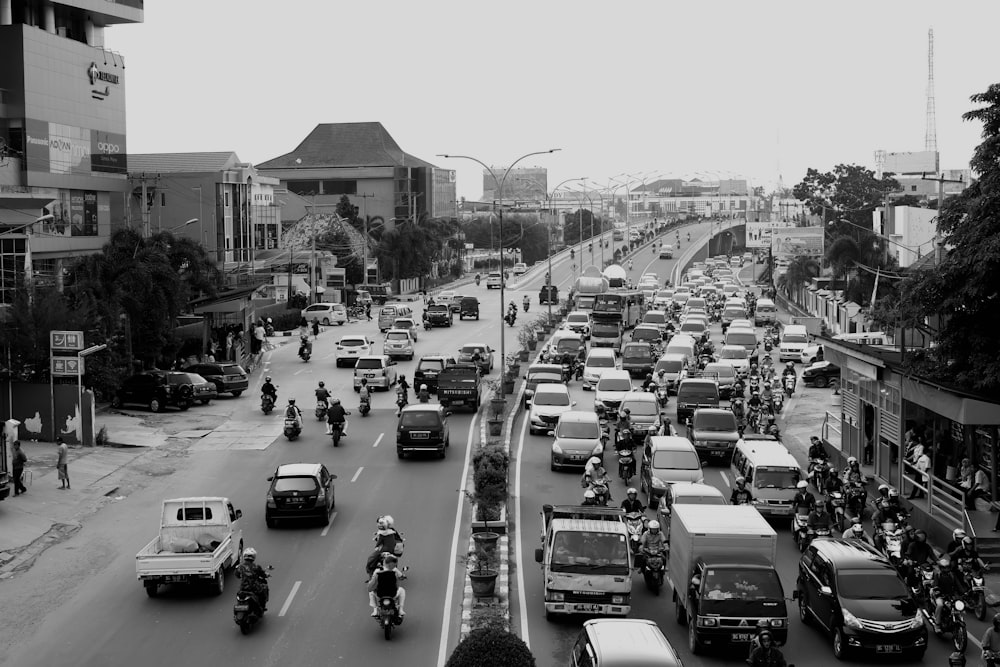 grayscale photo of vehicles on road