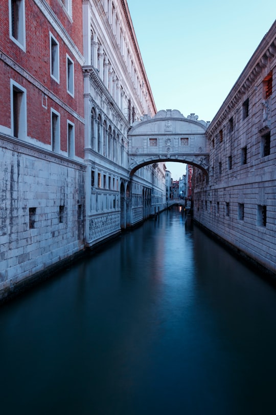 body of water between two white-and-gray concrete house in Bridge of Sighs Italy