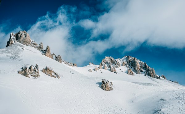 Snow-covered rock mountain under clods — Tignes, France