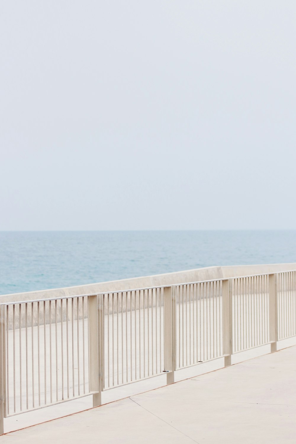 white metal handrails in a distance of sea