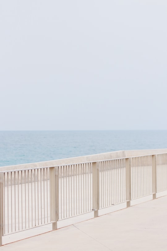 white metal handrails in a distance of sea in Mola di Bari Italy