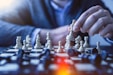 depth of field photography of man playing chess
