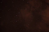 Artistic depiction of the Libra scales balancing under a starry night sky.
