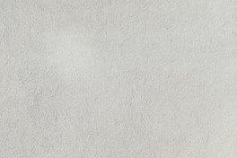 a close up of a white stucco wall