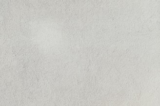 a close up of a white stucco wall