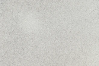 a close up of a white stucco wall