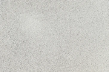a close up of a white stucco wall