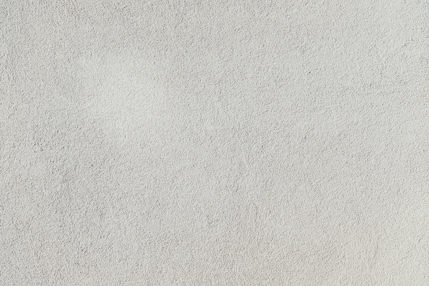 Close view of textured white exterior plaster, used to illustrate finish texture