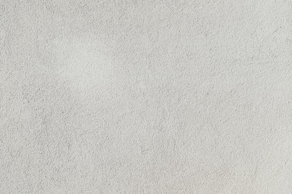 a close up of a white stucco wall