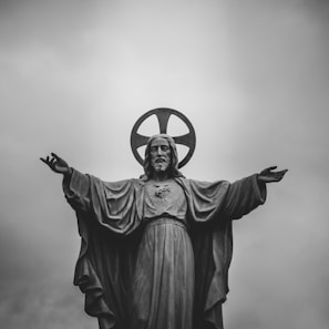 grayscale photograph of Jesus Christ statue