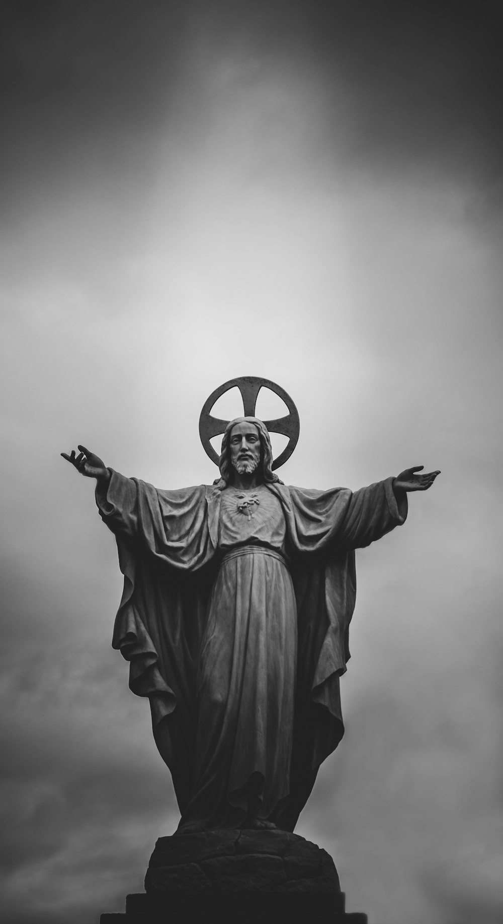 grayscale photograph of Jesus Christ statue
