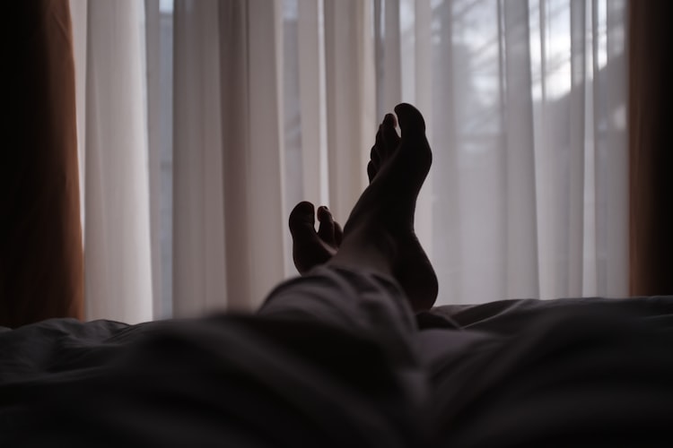 patient resting in hospital bed after rehab