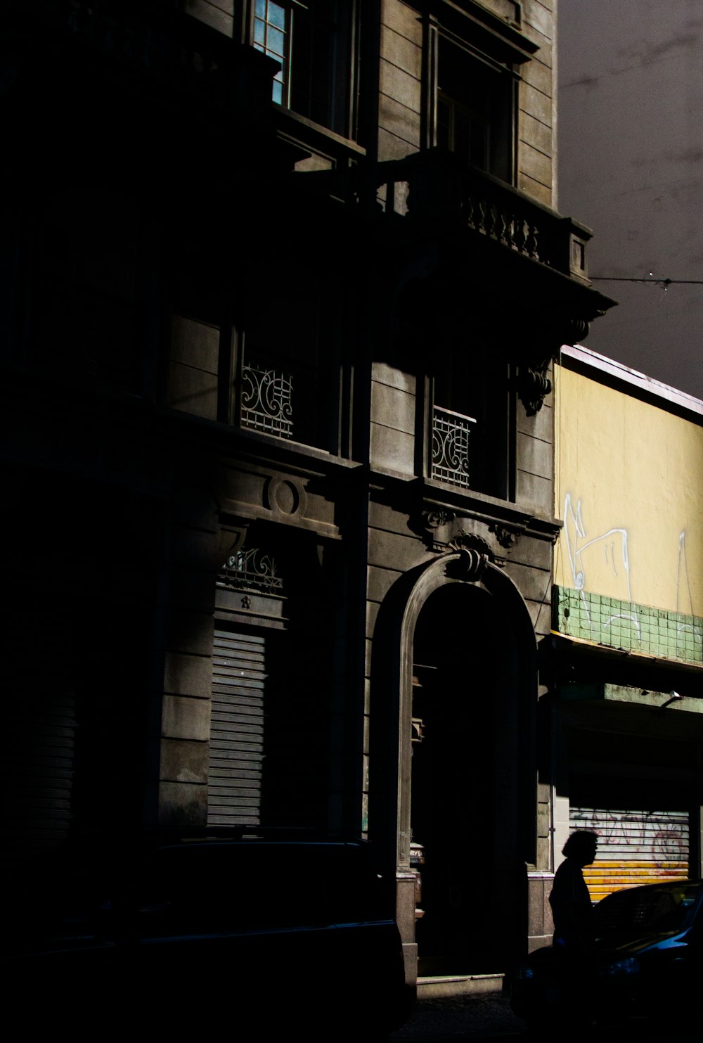 Silhouette of man in front of building