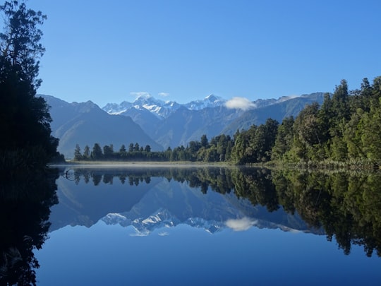 reflection landscape photography of lake in Lake Matheson New Zealand
