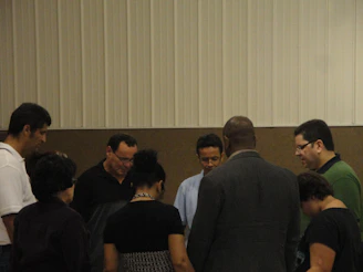 A serene group of people sitting in a circle, sharing spiritual stories in a warm, inviting room.