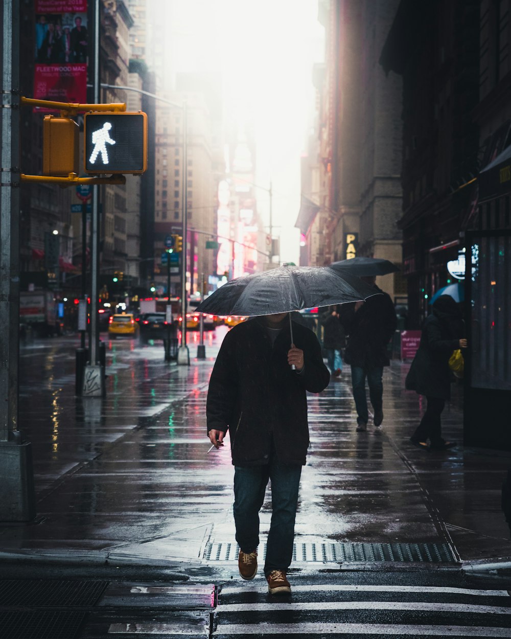 person walking on street during rainy day