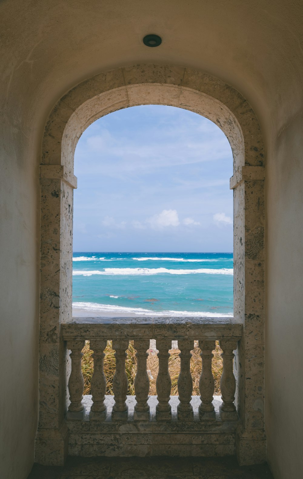 a balcony with a view of the ocean